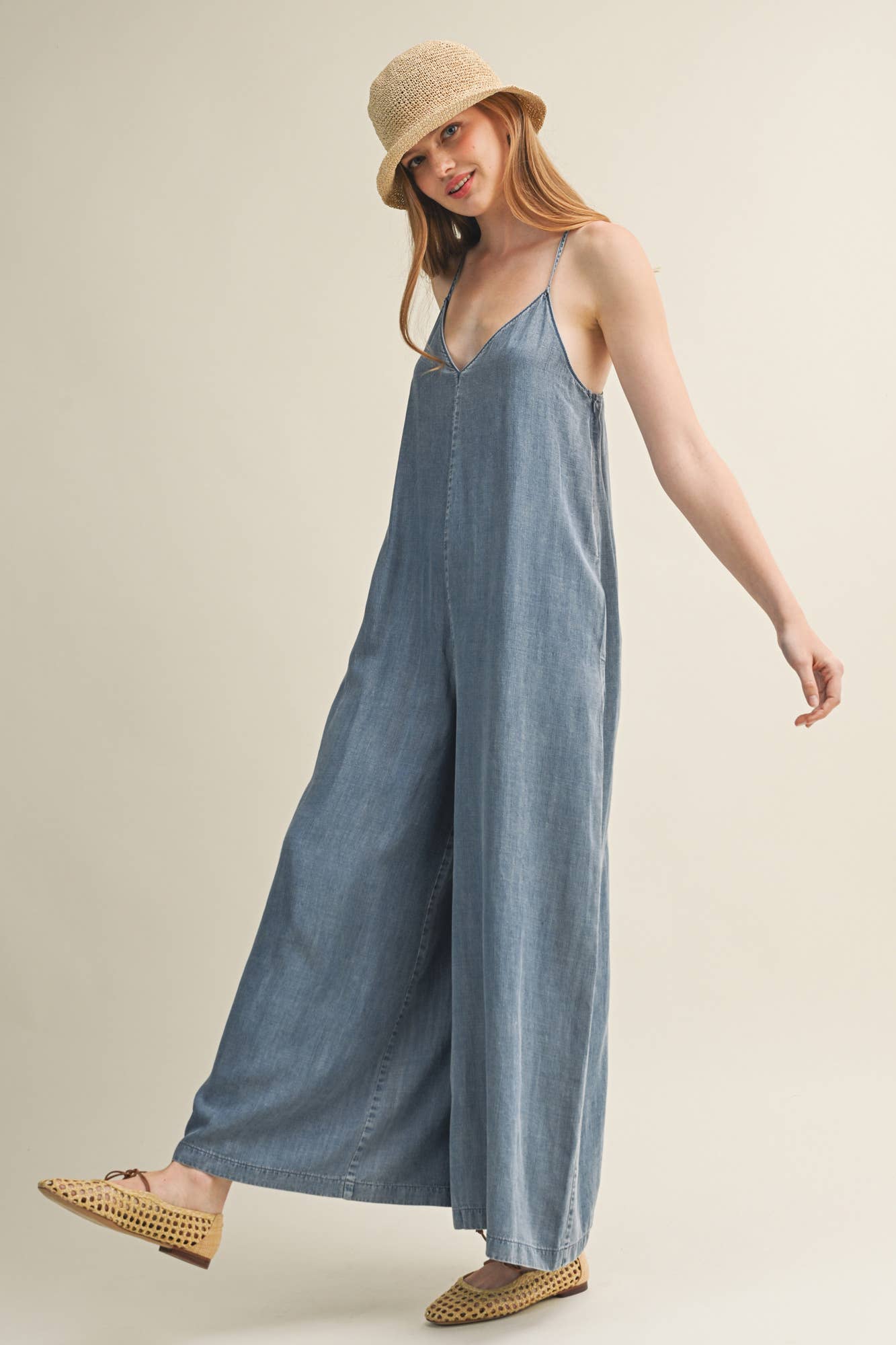SLEEVELESS DENIM JUMPSUIT WITH CROSS-BACK STRAPS